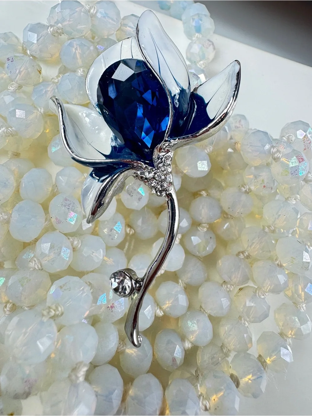 Silver Floral Brooch with Deep Blue Faceted Crystal